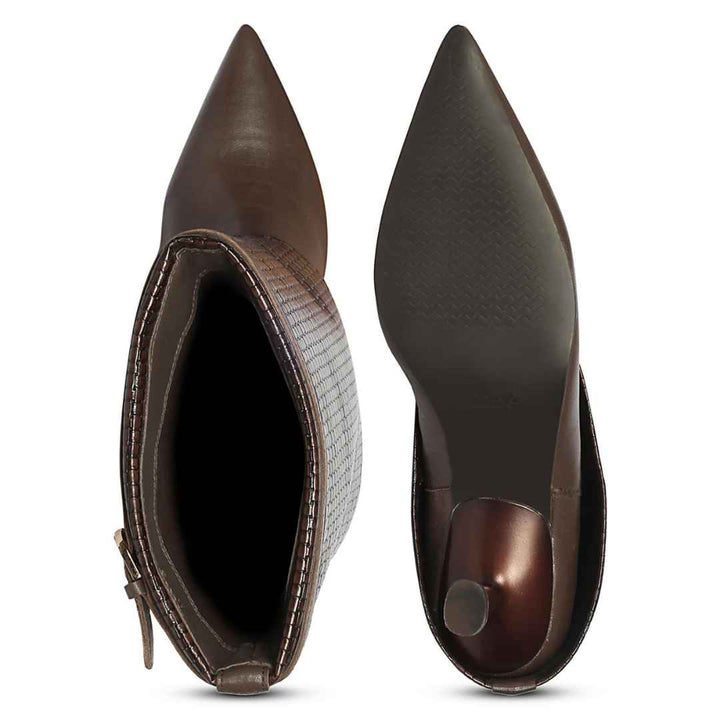 A pair of pointed-toe ankle boots shown from the side and sole views