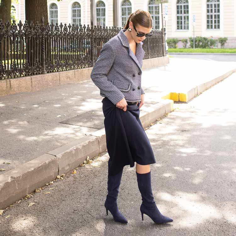 Woman in a gray jacket and navy skirt