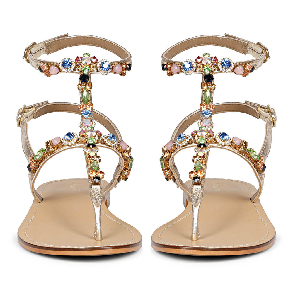 Front view of embellished platin sandals with multicolor stones arranged along central strap