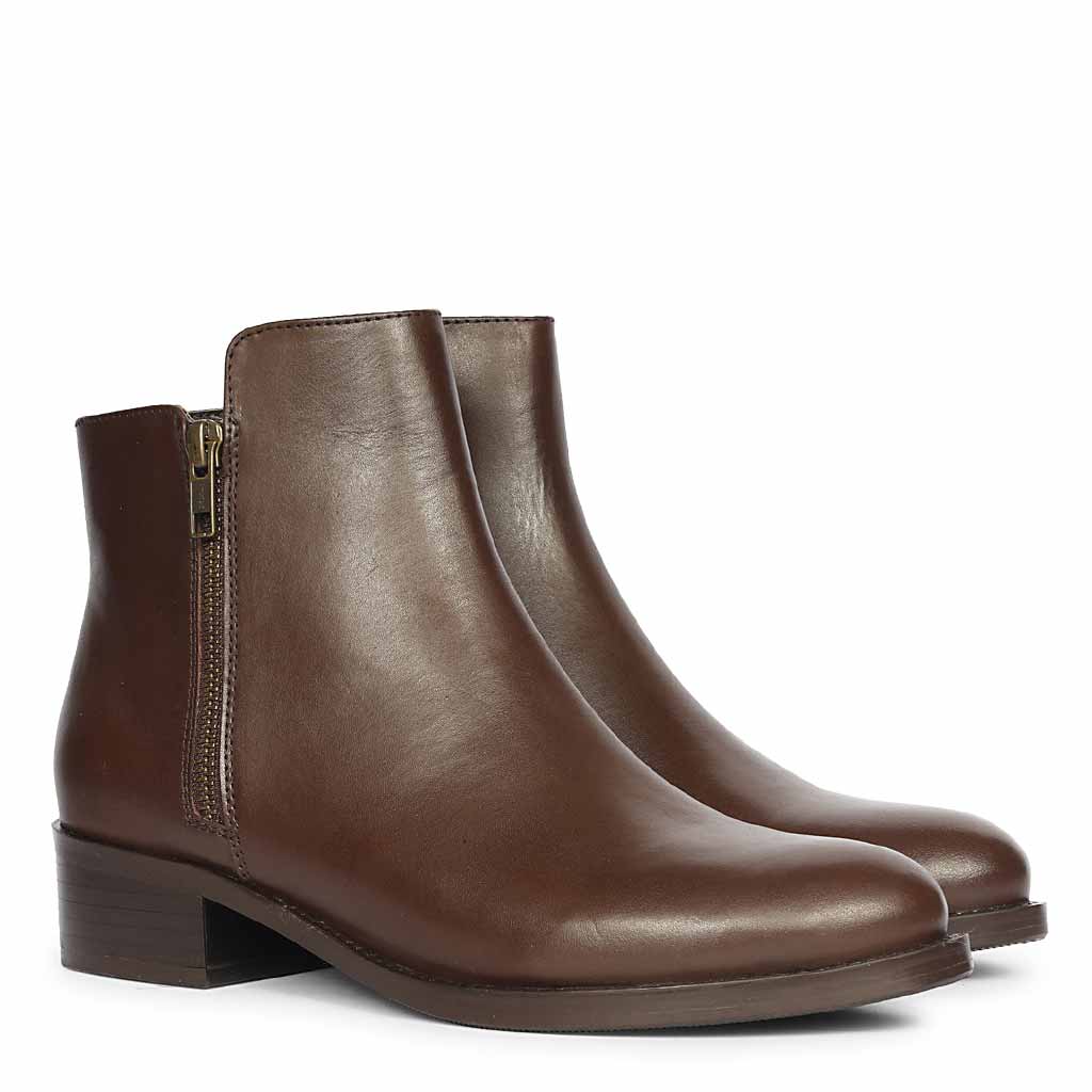 Pair of brown womens leather ankle boots shown from an angled side-front view