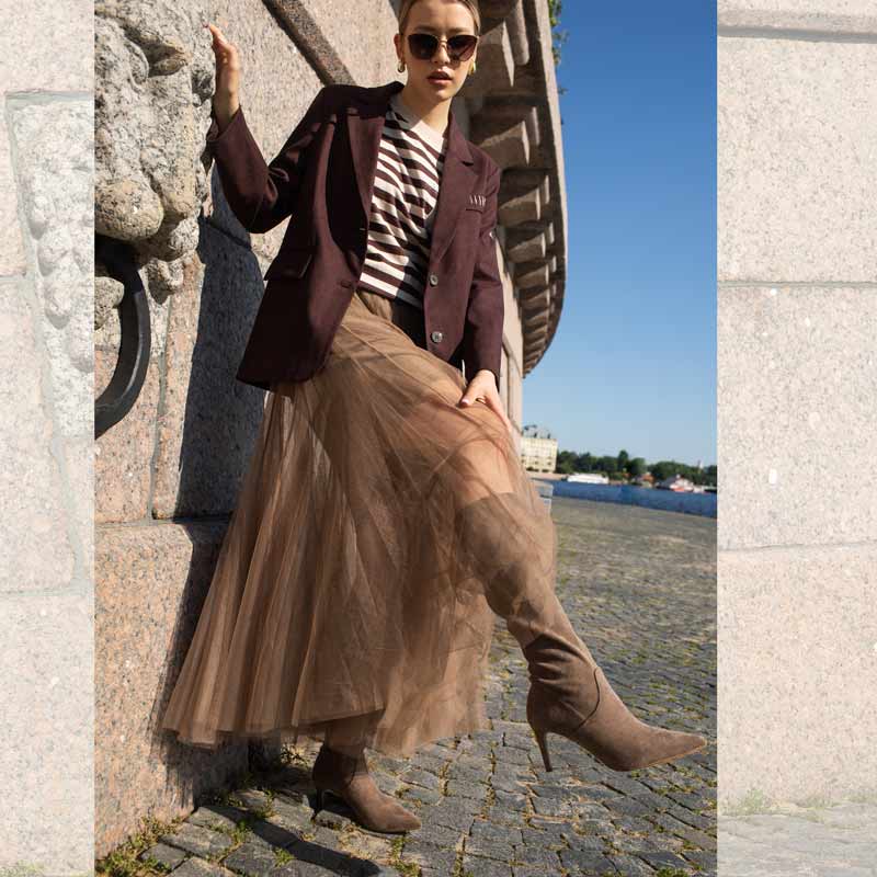 Woman in a stylish outfit with a brown jacket
