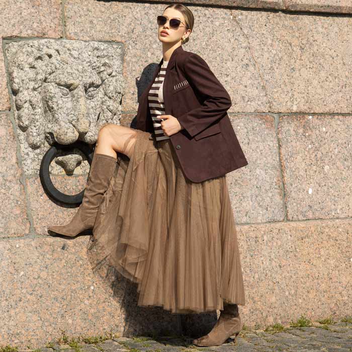 Woman in a brown jacket and skirt