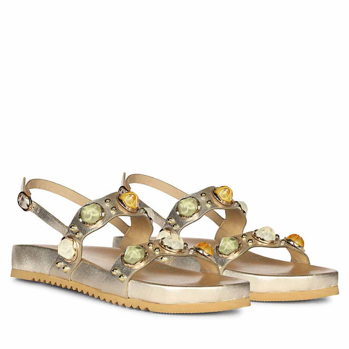 Embellished gold leather footbed sandals paired for occasion-ready styling