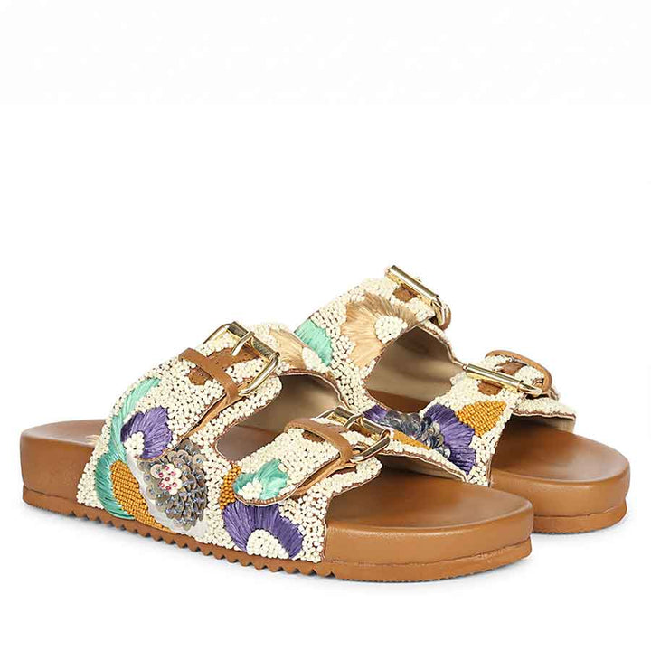 Women’s tan embroidered leather footbed sandals paired for luxury summer styling