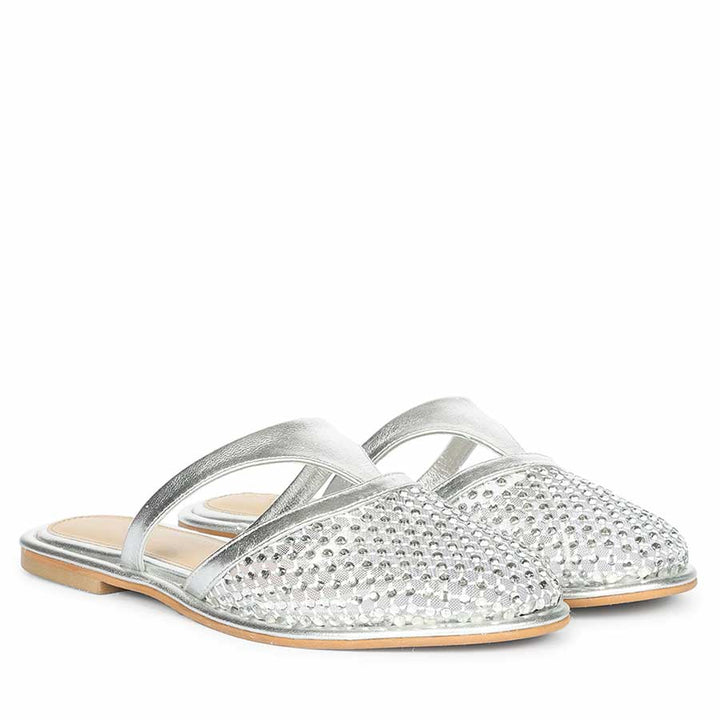 Silver crystal mesh mule flats paired for elegant day-to-evening looks