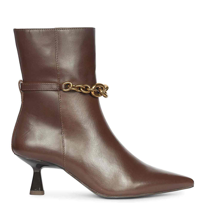 Brown pointed-toe leather ankle boot with slim heel and gold chain detail around the ankle