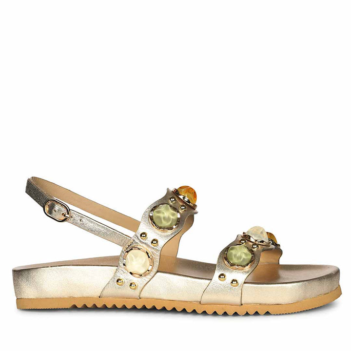 Side view of gold leather embellished footbed sandals with cushioned support