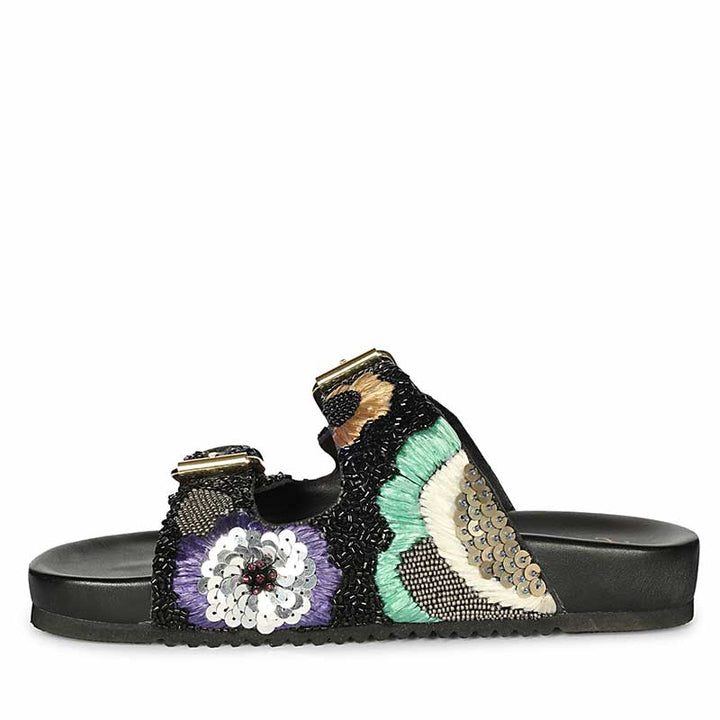 Decorative sandal with floral and sequin details on a white background