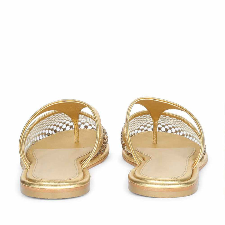 Rear view of gold leather mule flats with elegant slip-on styling