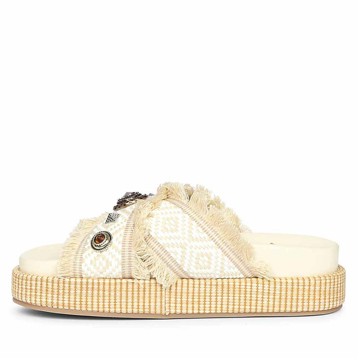 Beige sandal with decorative elements on a white background