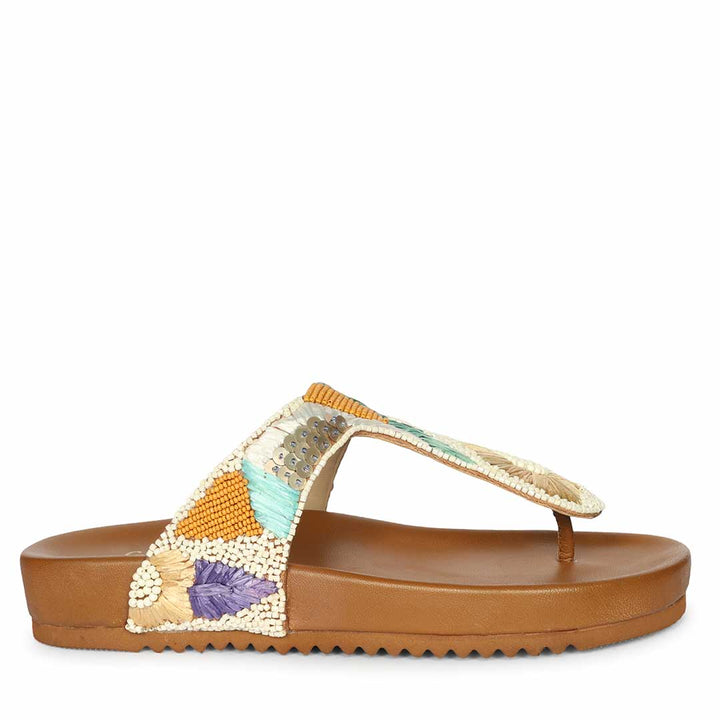 Side profile of tan leather thong sandals with cushioned comfort
