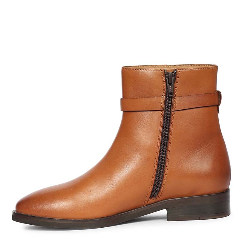 Side profile of tan leather ankle boot featuring an inside zipper and gold buckle strap