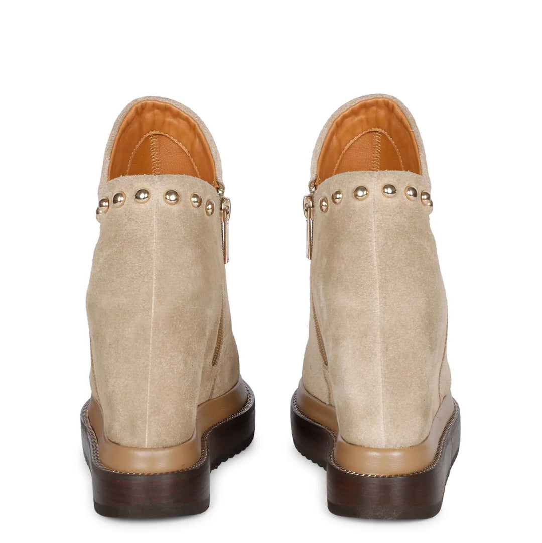 Pair of beige suede wedge ankle boots for women, back view