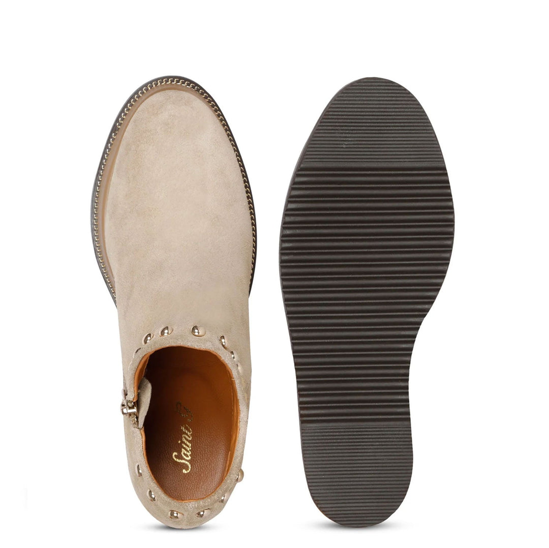 Sole and inside wedge of womens beige suede ankle boots