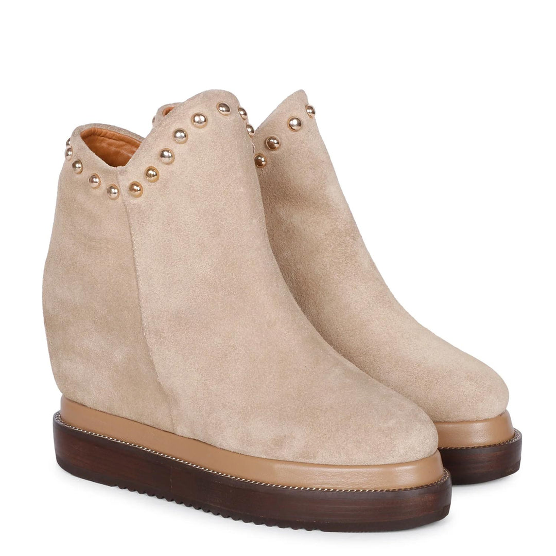 Beige suede wedge ankle boots for women with studs, angled view