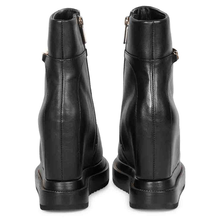 Pair of black leather wedge ankle boots for women, back view