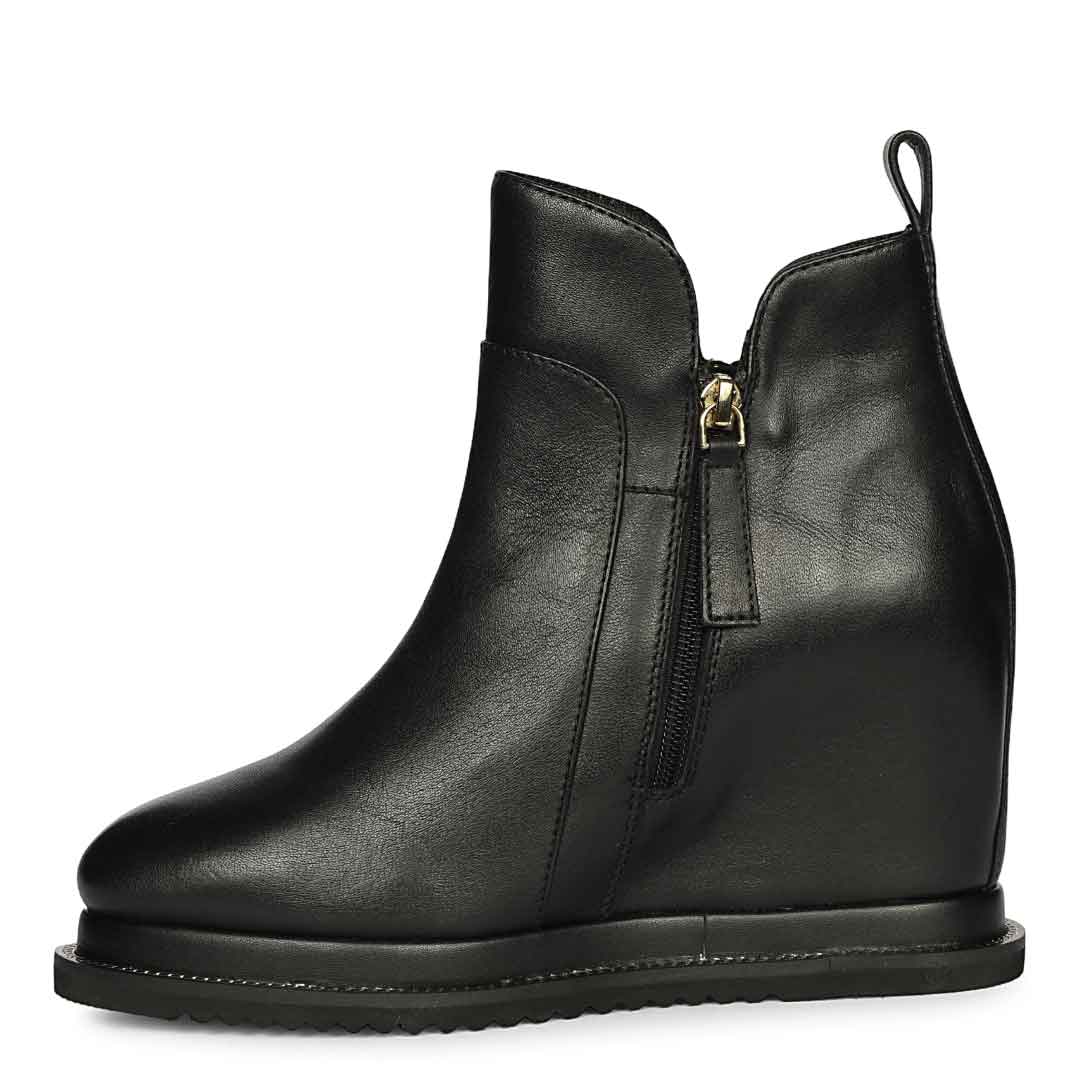 Black leather wedge ankle boots for women with high inside wedge, side profile