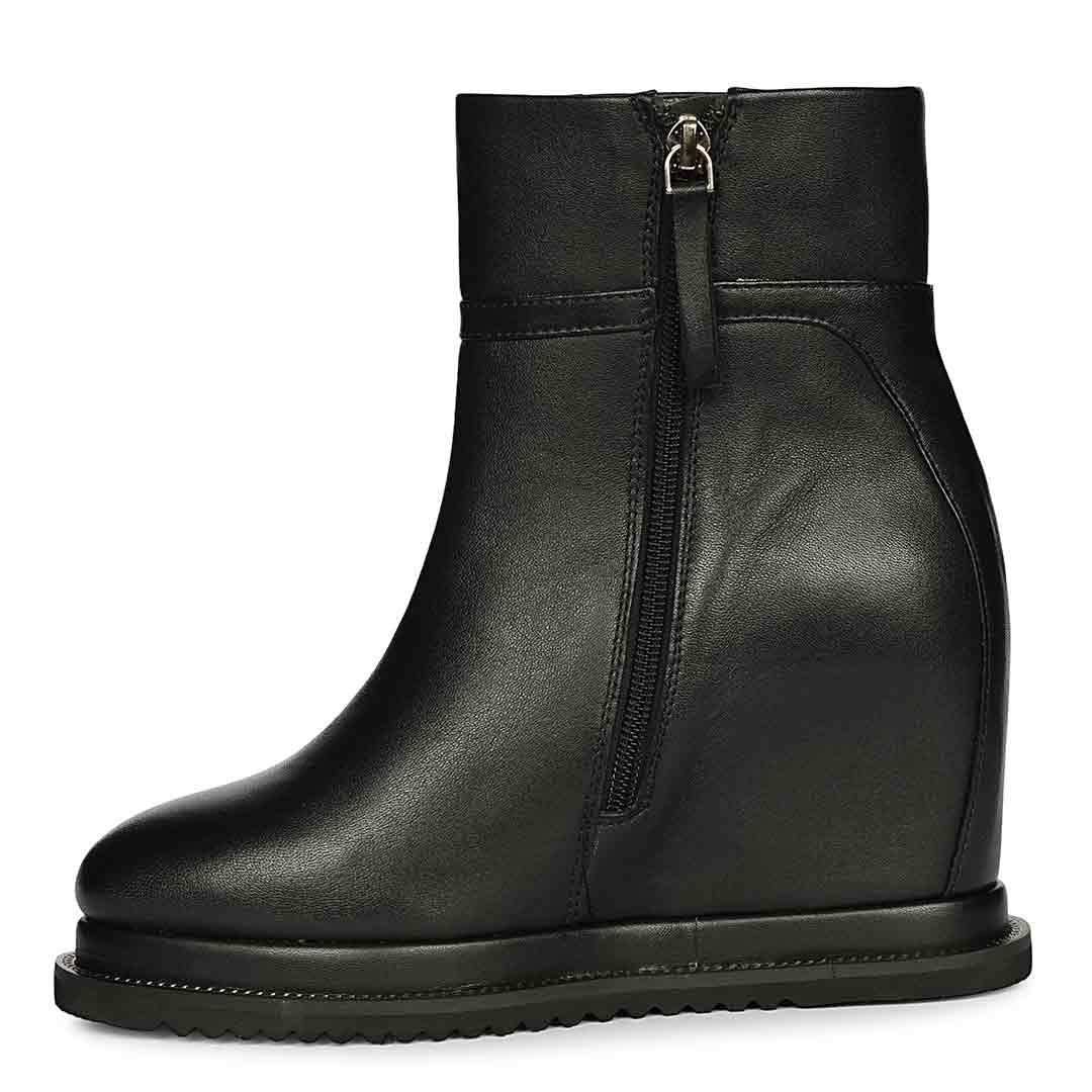 Black leather wedge ankle boots for women with high inside wedge, side profile