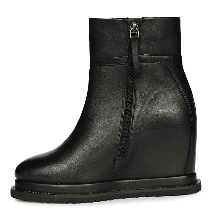 Black leather wedge ankle boots for women with high inside wedge, side profile