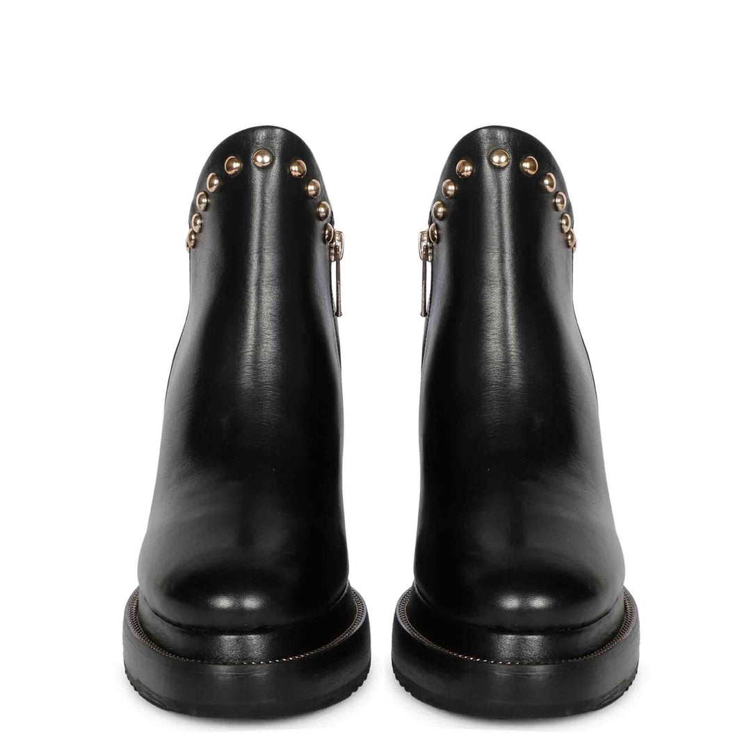 Pair of black leather studded wedge ankle boots for women, front view