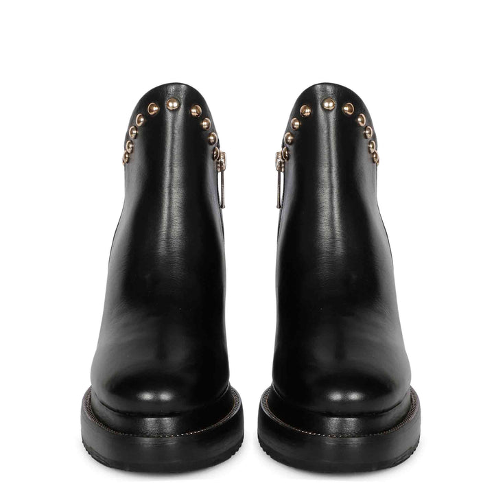 Pair of black leather studded wedge ankle boots for women, front view
