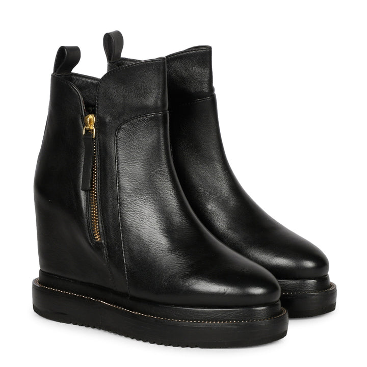 Black leather wedge ankle boots for women with gold zip, angled view