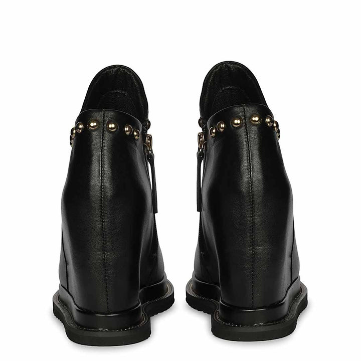 Pair of black studded leather wedge ankle boots for women,  back views