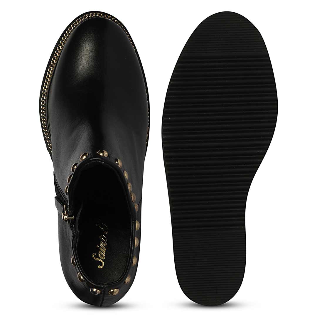 Sole and inside wedge of womens black studded leather ankle boots
