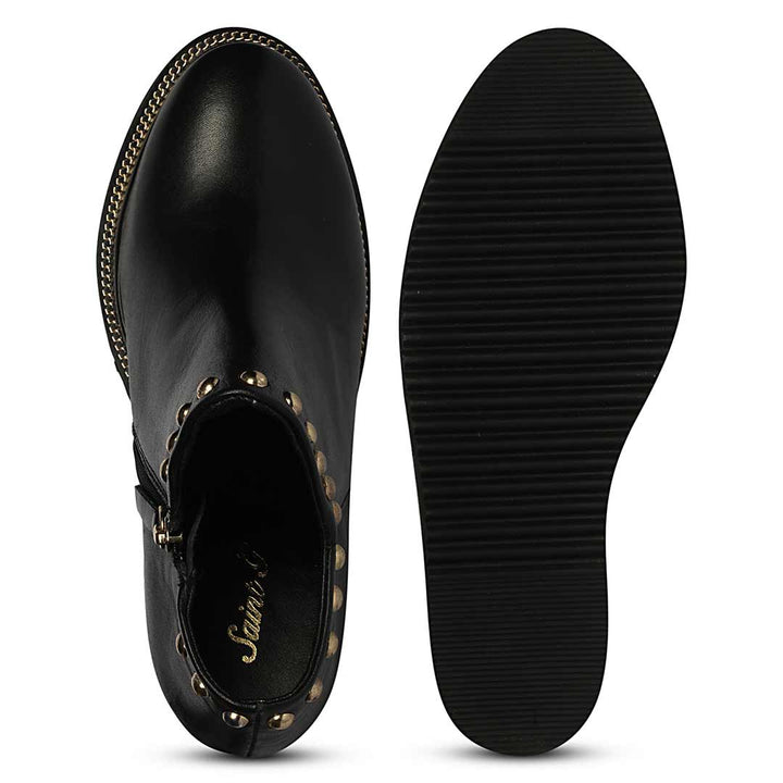 Sole and inside wedge of womens black studded leather ankle boots