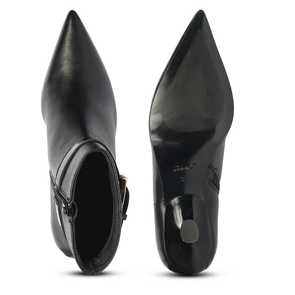 Top and bottom view of black ankle boots highlighting pointed toe shape and sole design