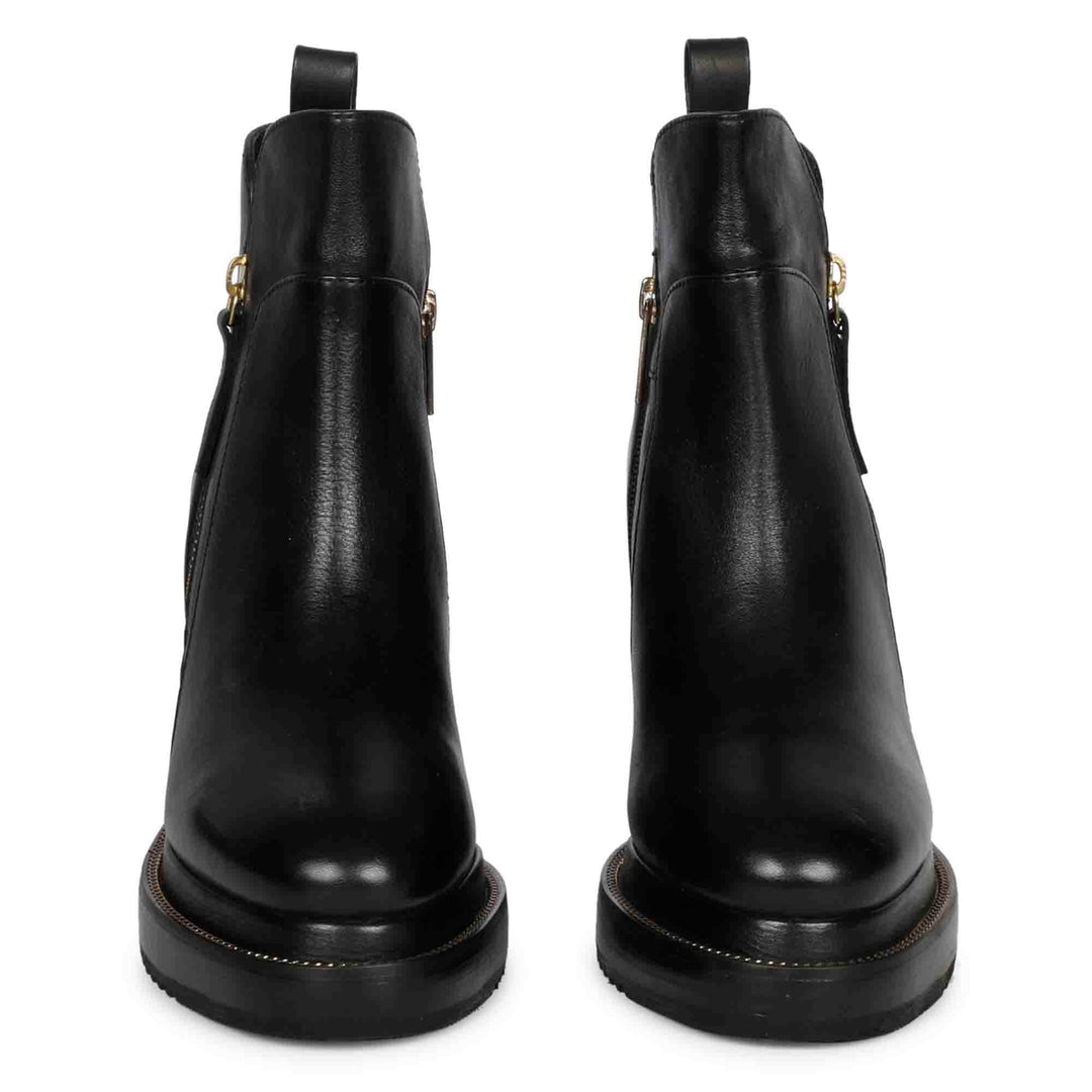 Pair of ladies black leather wedge ankle boots, front view
