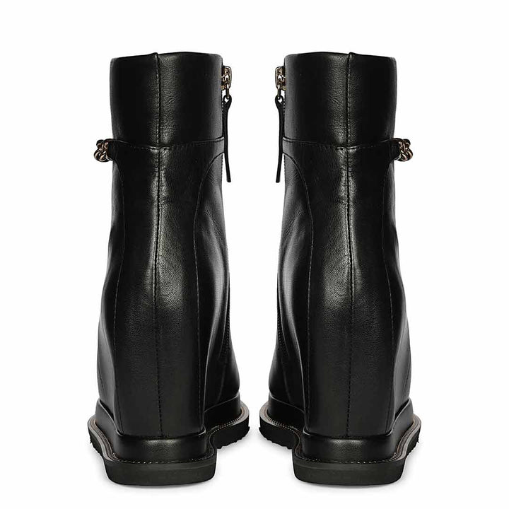 Pair of ladies black leather wedge ankle boots, back view