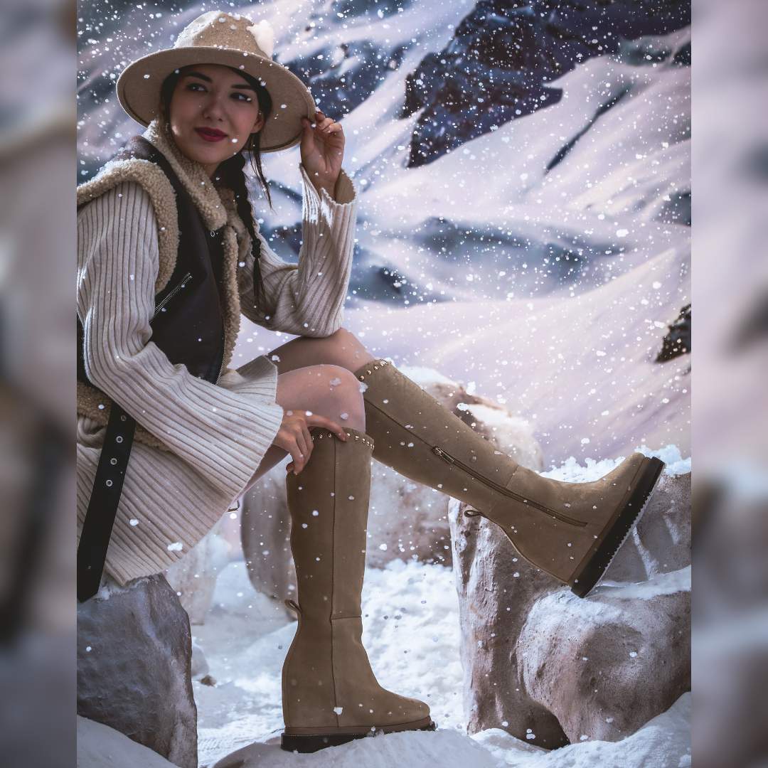 Model wearing ladies ivory suede wedge boots in a winter setting