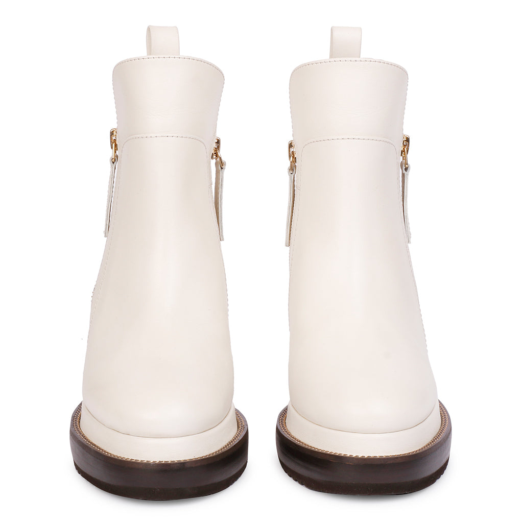 Pair of ladies off-white leather wedge ankle boots, front view