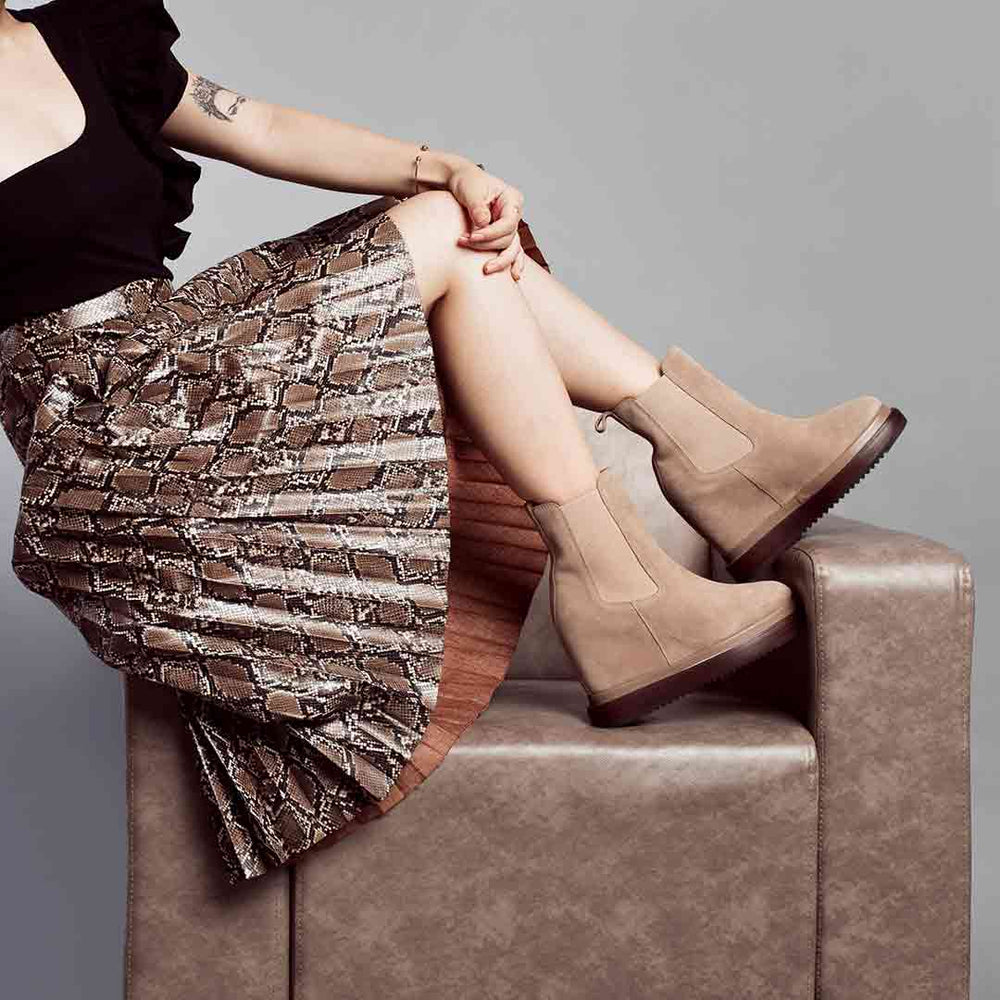 Model wearing ladies sand suede wedge ankle boots, styled look