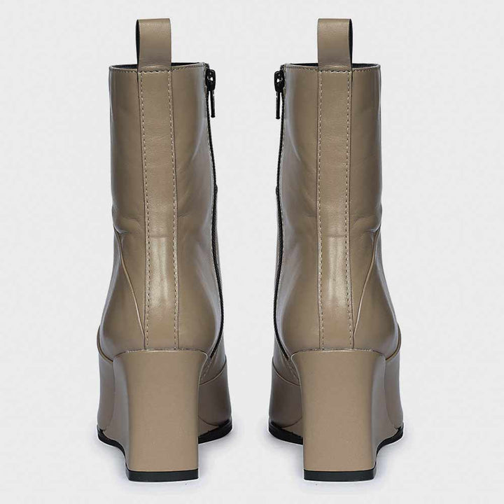 Pair of ladies stone leather wedge ankle boots, back view