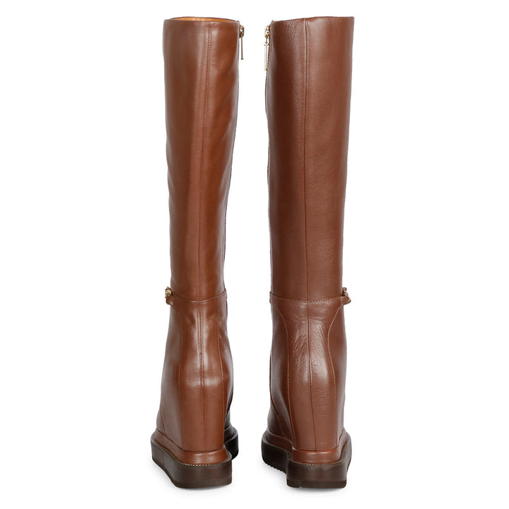 Pair of ladies tan leather wedge long boots, back view