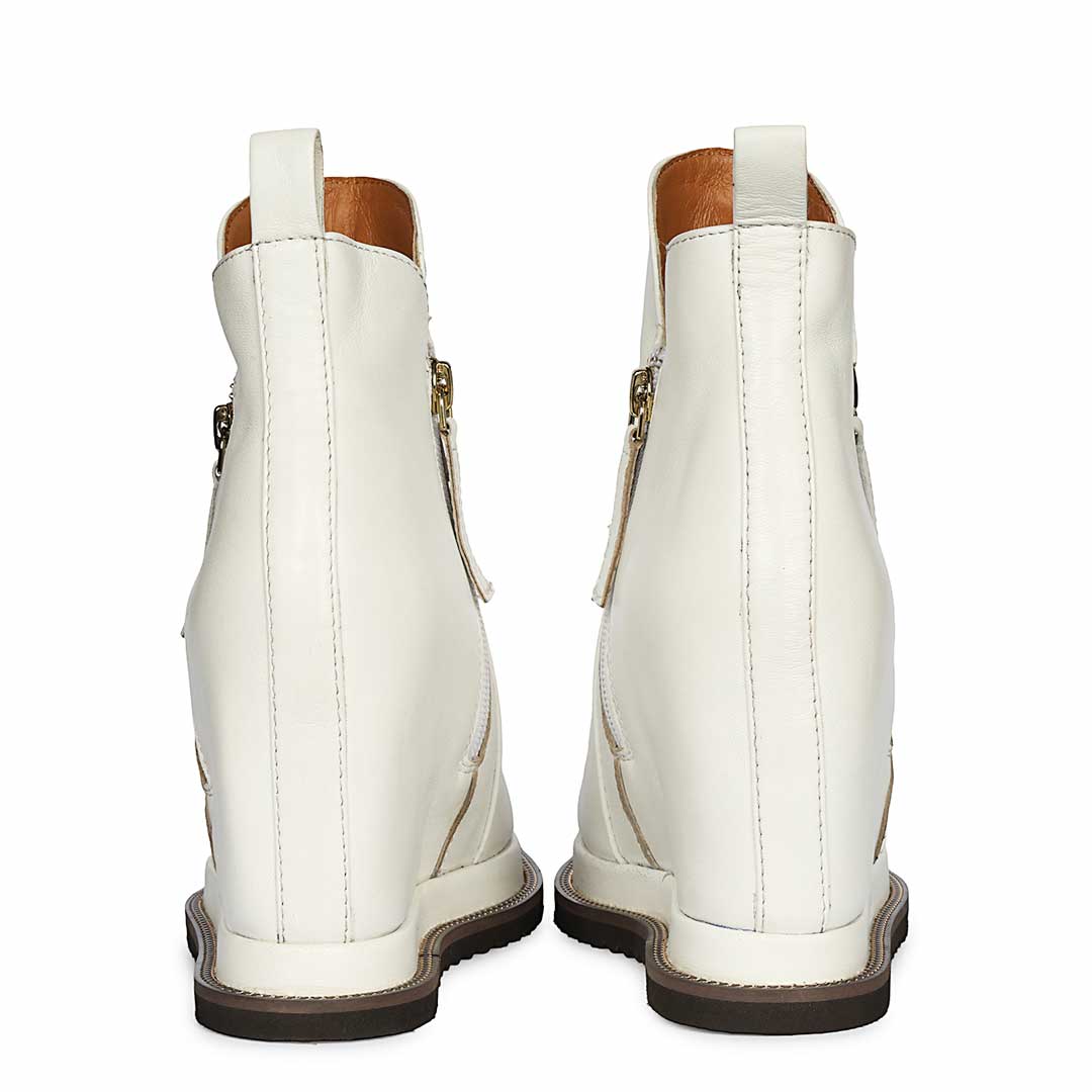 Pair of ladies white leather wedge ankle boots, back angled view