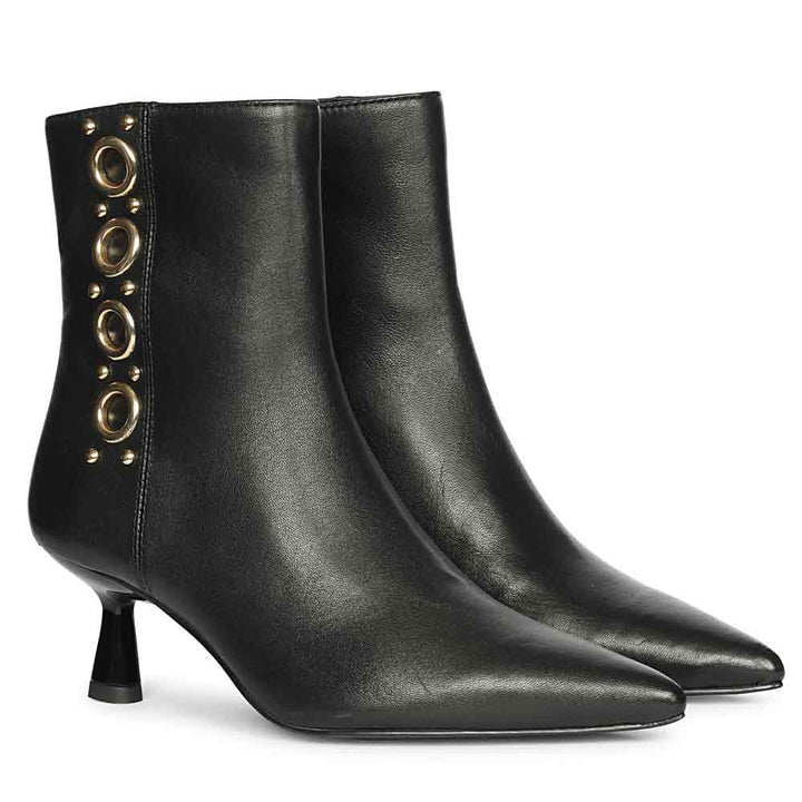 Pair of black embellished ankle boots with pointed toes, kitten heels, and gold eyelet detailing