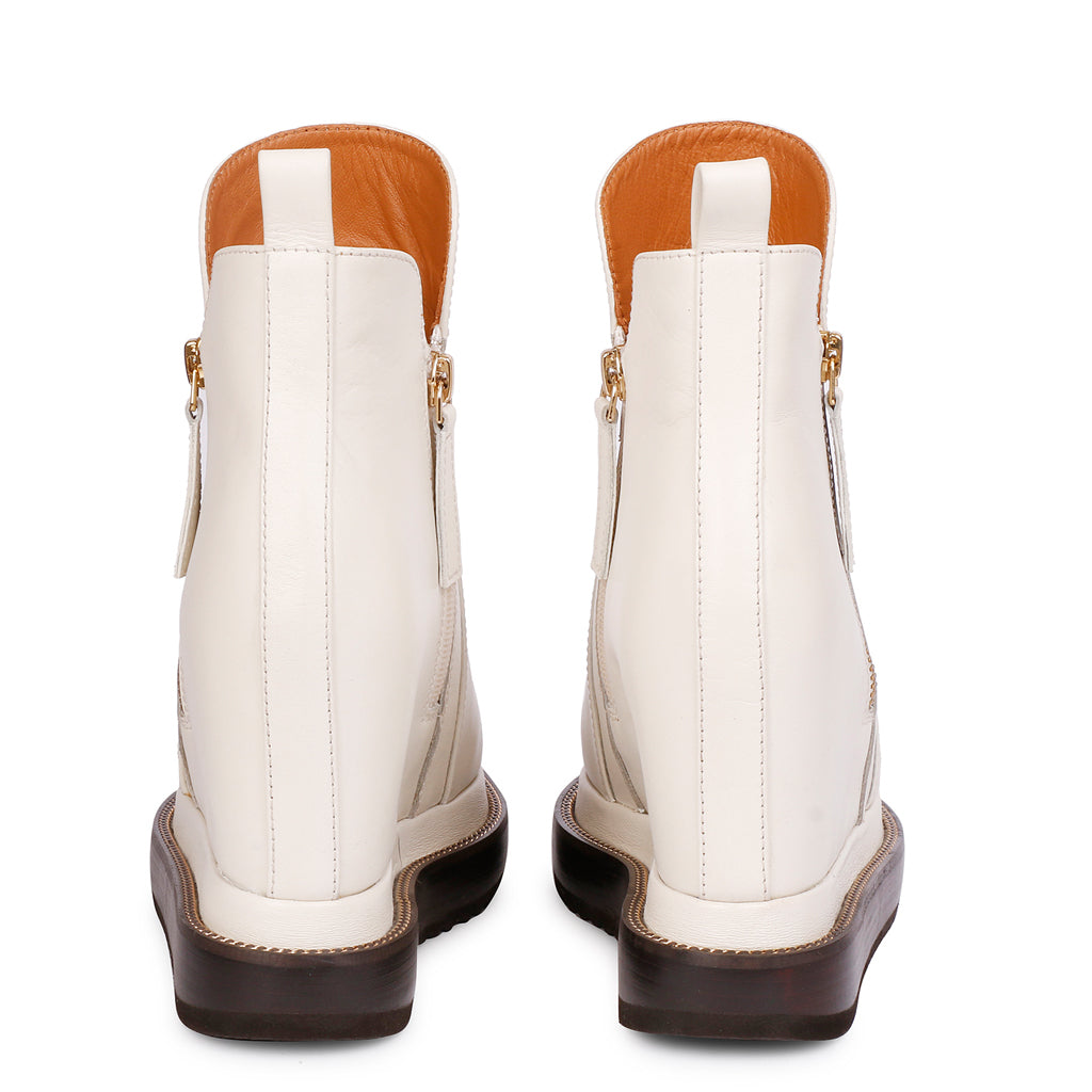 Pair of off-white leather wedge ankle boots for women, back view