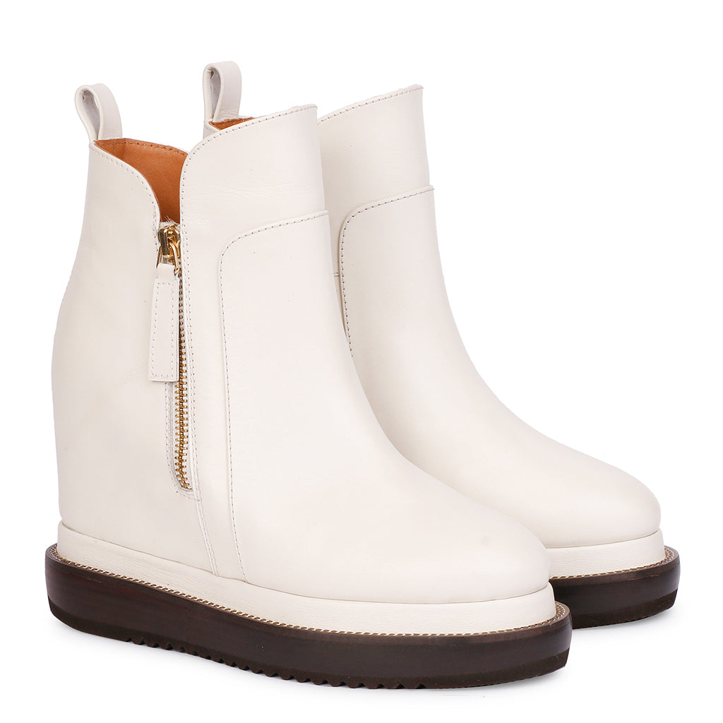 Off-white leather wedge ankle boots for women with gold zip, angled view