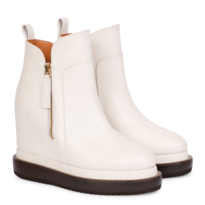 Off-white leather wedge ankle boots for women with gold zip, angled view
