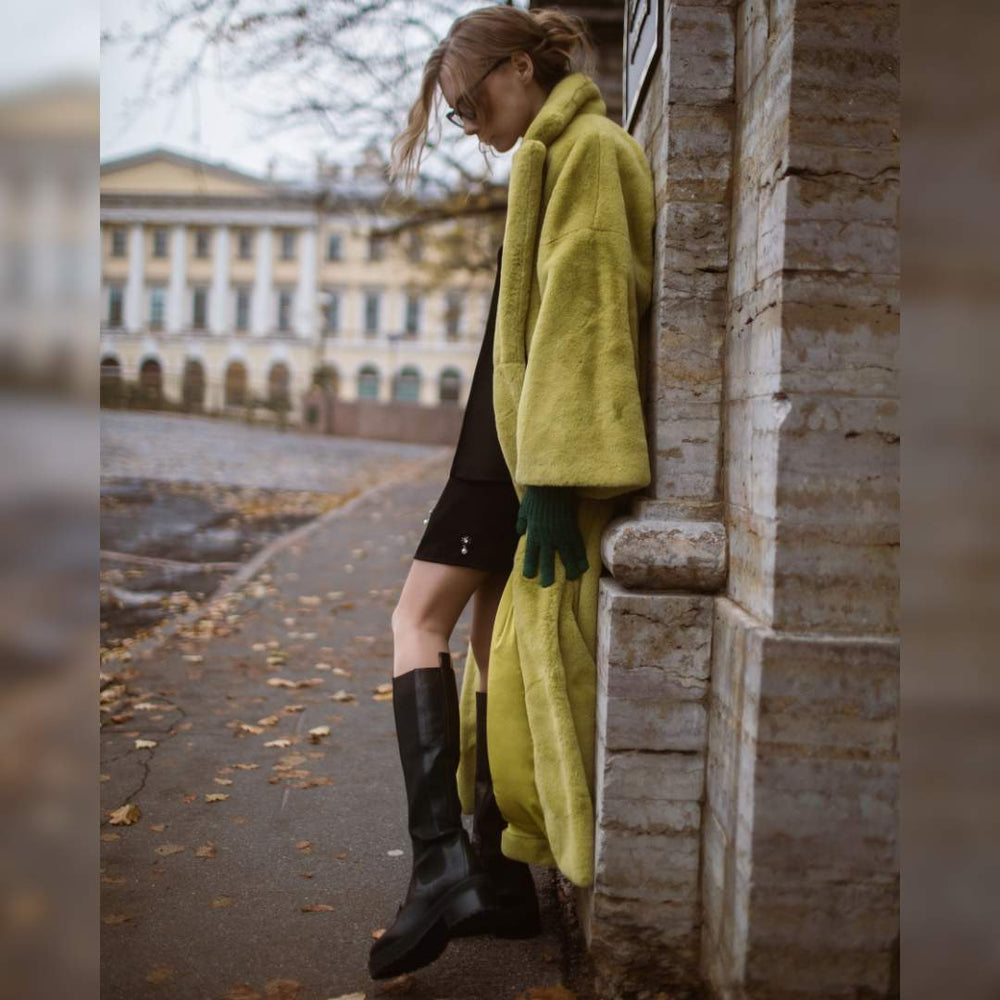 Women's black leather knee high boots by Saint Adriana, styled street-style lifestyle shot