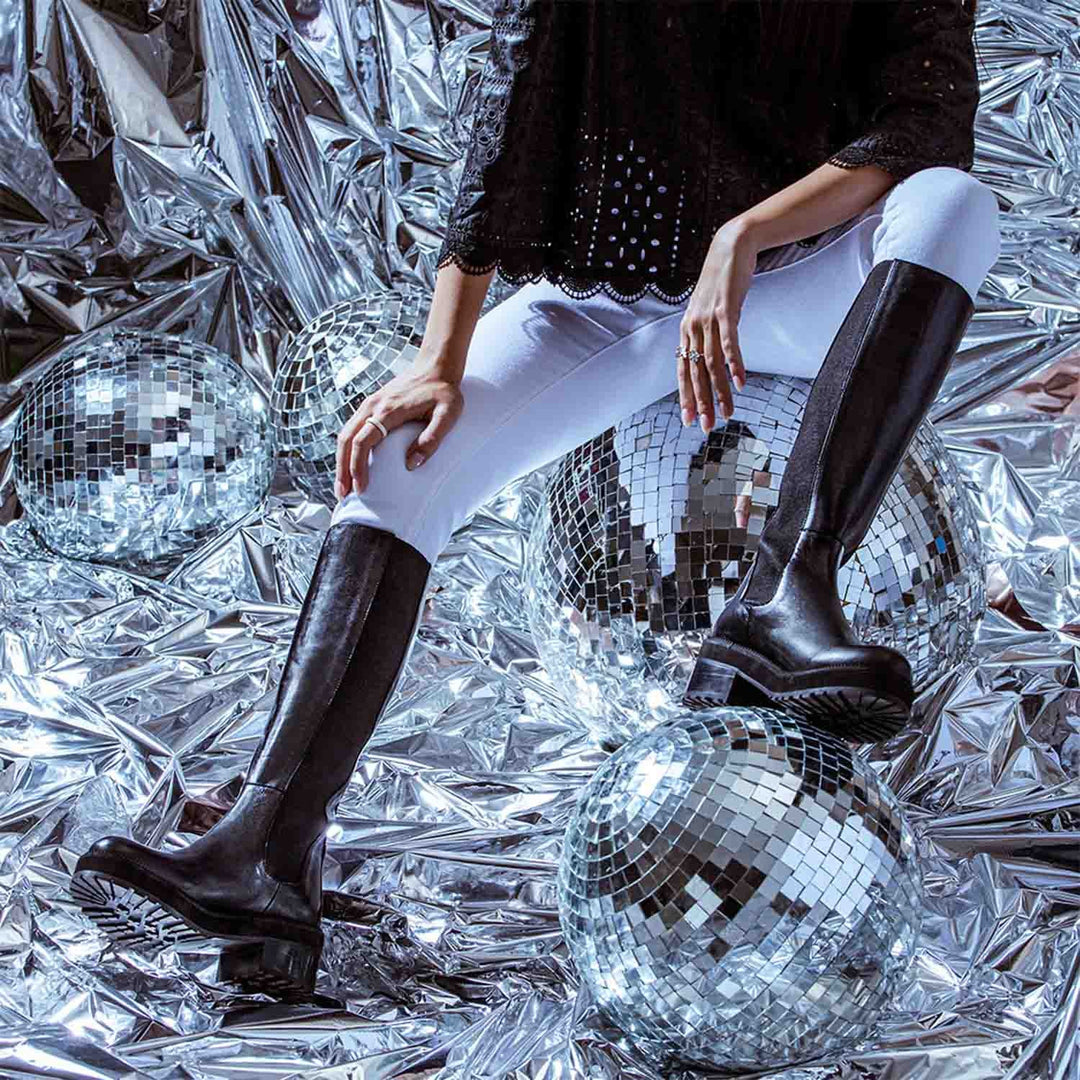 Saint Adriana black leather knee high boots, styled editorial shot with disco ball props