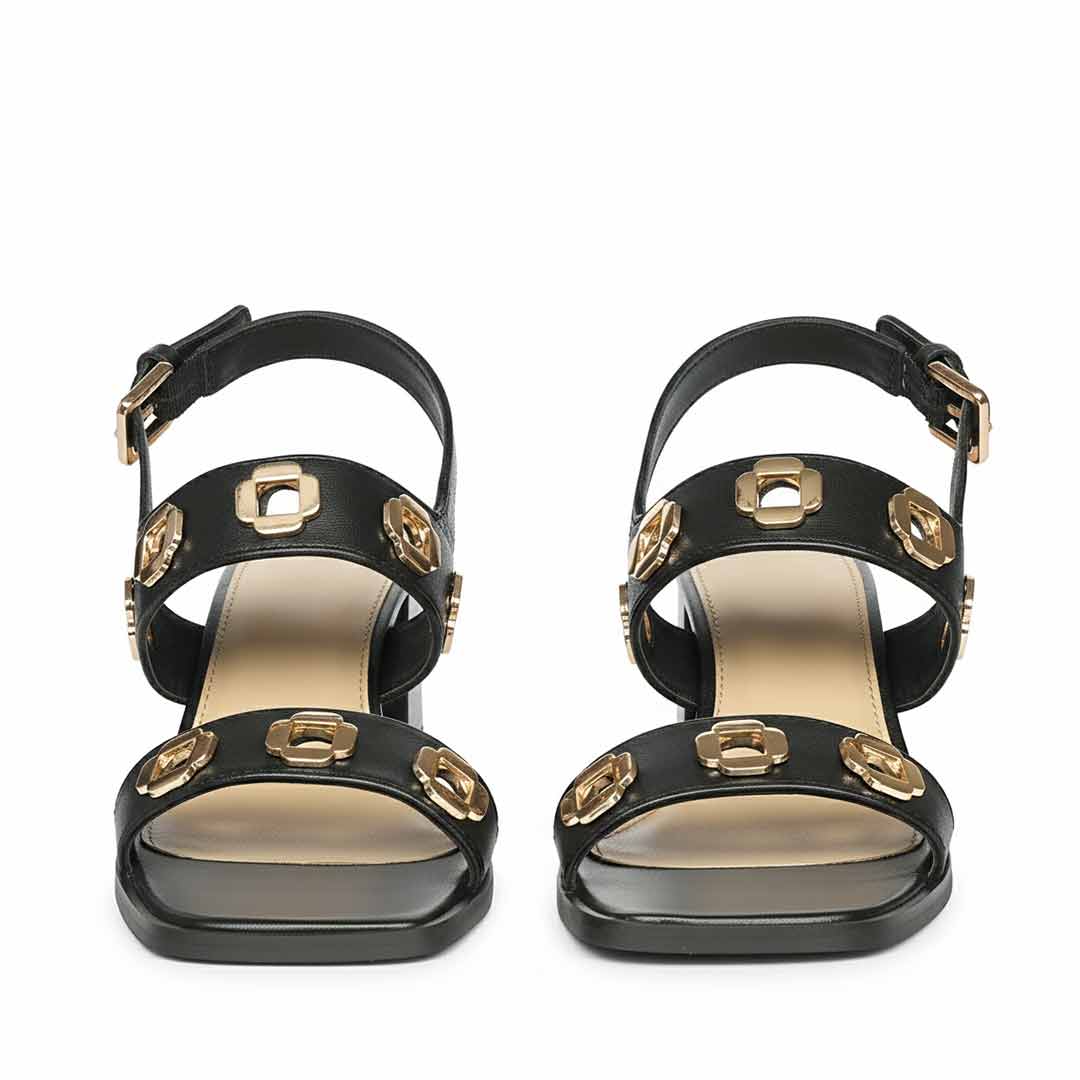 Black low block heel sandals with gold embellishments - front view