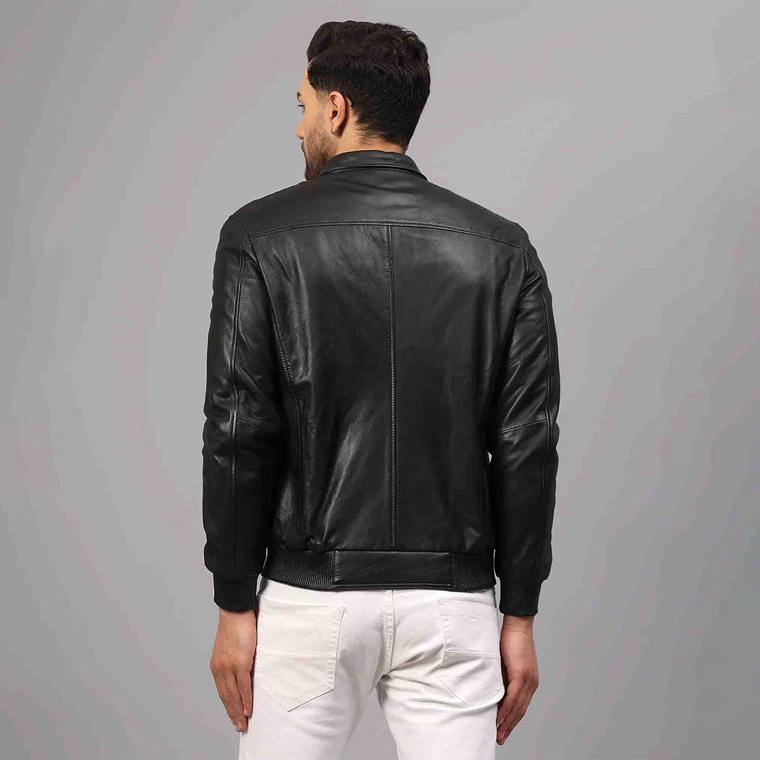 Back view of a black leather bomber jacket showing the ribbed hem and cuffs.