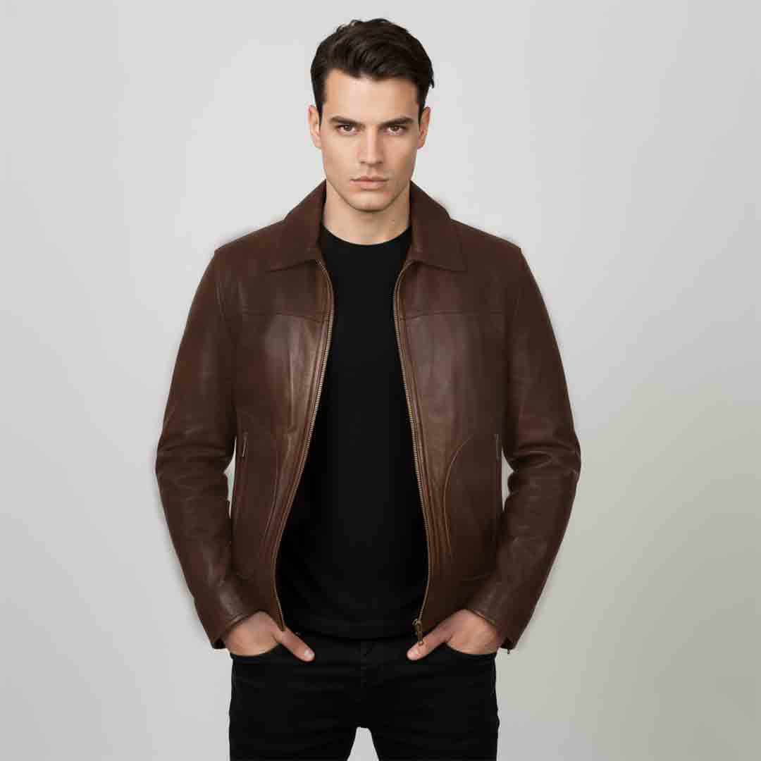 Man wearing an open chocolate brown leather bomber jacket over a black top.