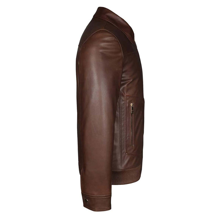 Close-up side view of a brown leather bomber jacket's sleeve and zip pocket.