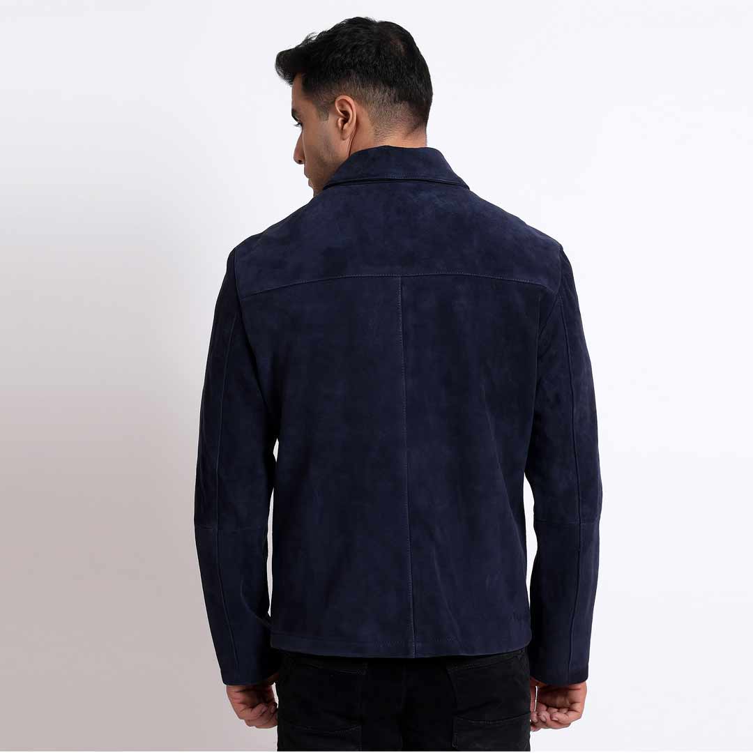 Back view of a man wearing a navy suede jacket.