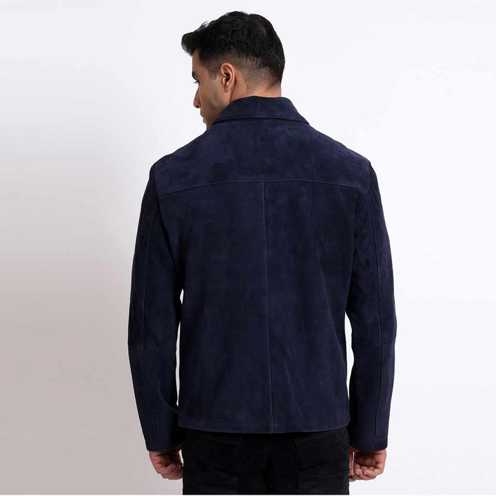 Back view of a man wearing a navy suede jacket.